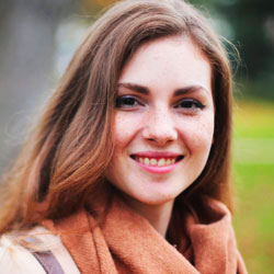 Functional Therapeutics Swfl - A young woman in a brown scarf smiling in the park undergoes posture correction with the help of Massage Therapists Fort Myers.