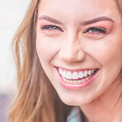 Functional Therapeutics Swfl - A woman receiving a therapeutic massage with a smile on her face.