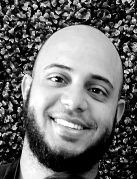 Functional Therapeutics Swfl - A bald man smiling in a black and white photo, possibly associated with massage therapy.