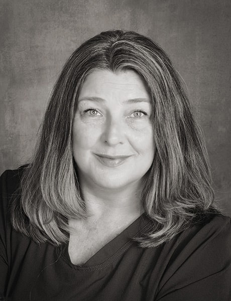 Functional Therapeutics Swfl - A black and white photo of a woman with long hair showcasing therapeutic massage.