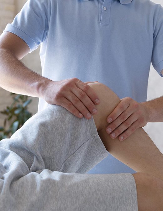 Functional Therapeutics Swfl - A man receives knee massage from a therapist specialized in posture correction.